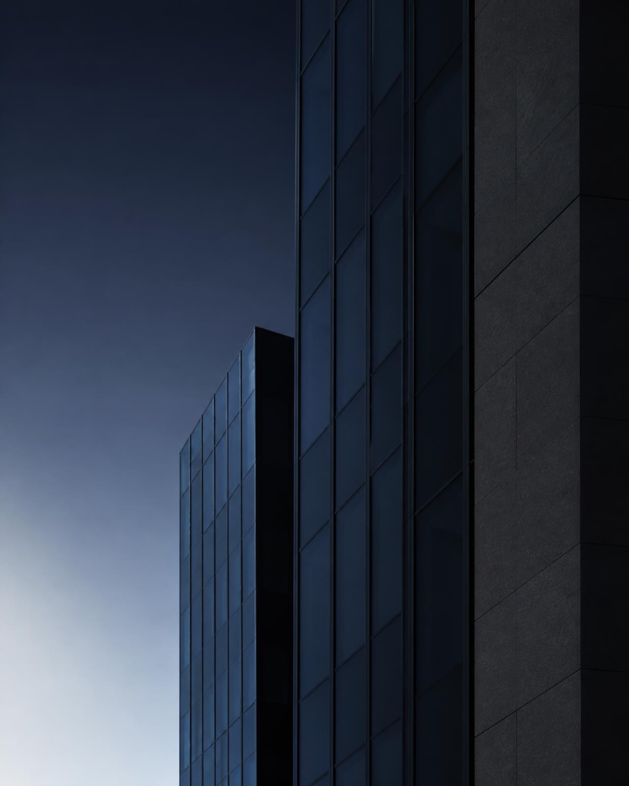 Abstract detail of a modern corporate tower facade at dusk